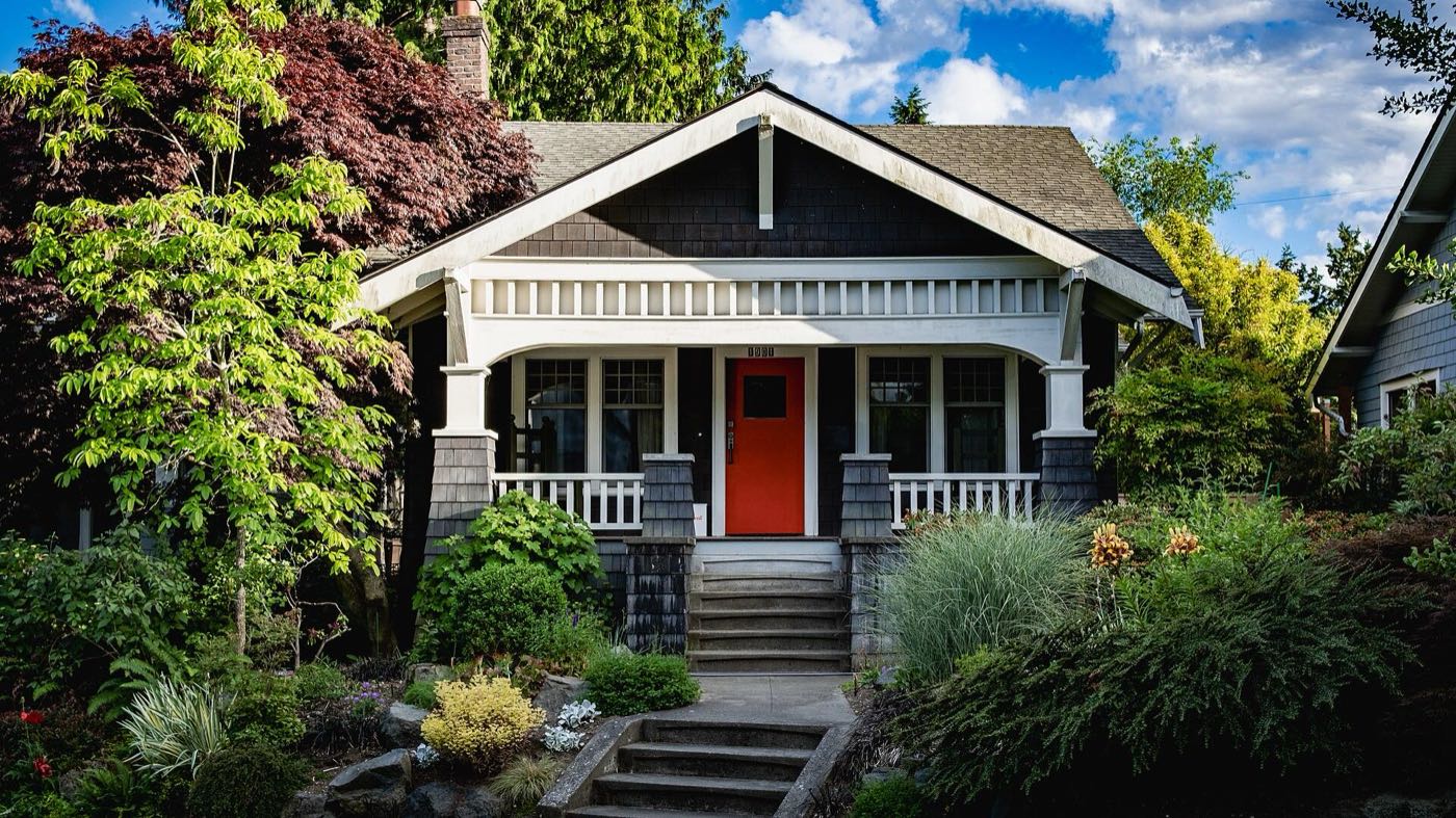 Craftsman bungalow with a red door in Seattle
